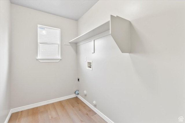 washroom with washer hookup, hookup for a gas dryer, electric dryer hookup, light wood-style floors, and baseboards