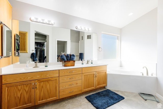 full bathroom featuring double vanity, a garden tub, tile patterned floors, and lofted ceiling