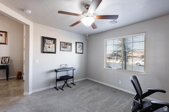 office space featuring a ceiling fan, baseboards, and carpet flooring