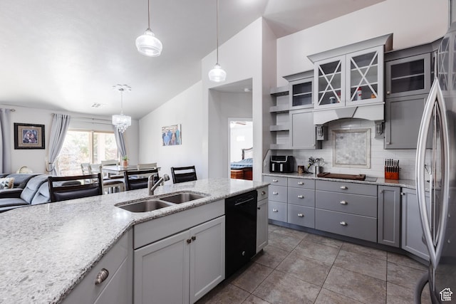 kitchen with black dishwasher, a sink, gray cabinets, vaulted ceiling, and decorative backsplash