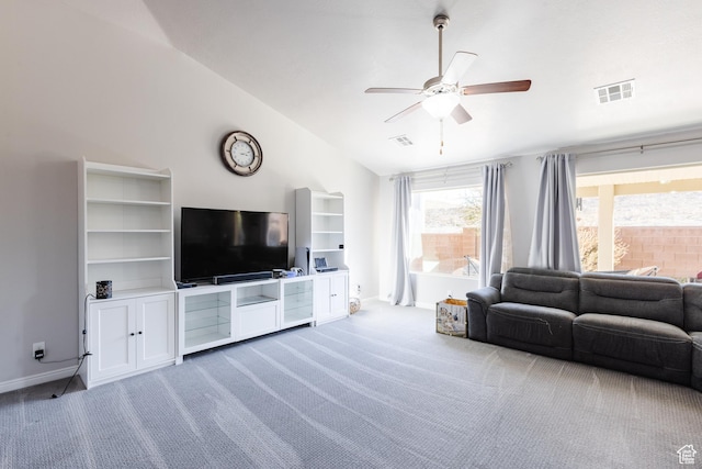 living area featuring vaulted ceiling, a ceiling fan, carpet, and baseboards
