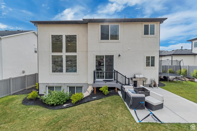 5402 N Meadow Lark Ln, Lehi, UT 84043 - back of house with a trampoline, stucco siding, a patio, and an outdoor living space