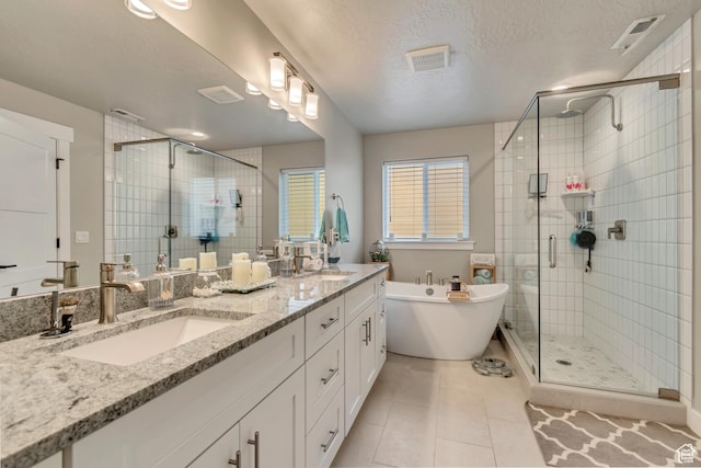 5402 N Meadow Lark Ln, Lehi, UT 84043 - full bath with a stall shower, a soaking tub, double vanity, tile patterned flooring, and a textured ceiling
