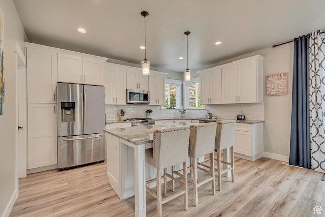 5402 N Meadow Lark Ln, Lehi, UT 84043 - kitchen featuring appliances with stainless steel finishes, tasteful backsplash, light wood-type flooring, white cabinetry, and recessed lighting