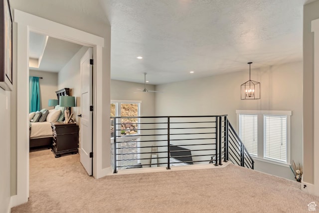 5402 N Meadow Lark Ln, Lehi, UT 84043 - hall with an upstairs landing, carpet, a chandelier, recessed lighting, and a textured ceiling