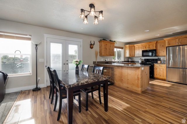 730 S 500 E, Roosevelt, UT 84066 - dining room featuring wood finished floors, french doors, a chandelier, and baseboards