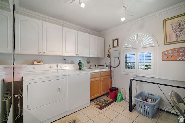 clothes washing area with cabinet space, washer and clothes dryer, track lighting, light tile patterned floors, and crown molding