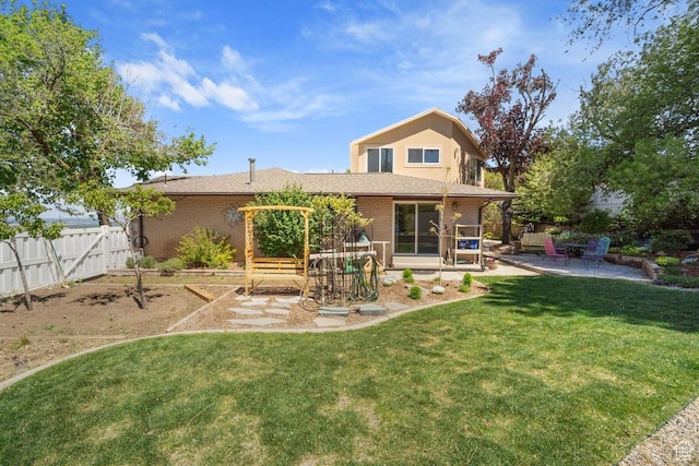 back of property with a patio area and brick siding