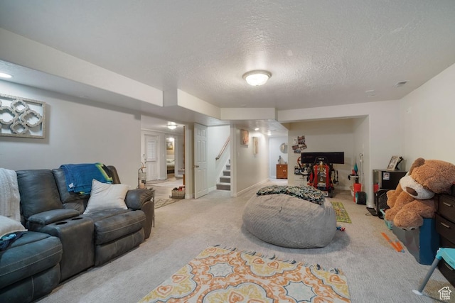 carpeted living area featuring a textured ceiling and stairs