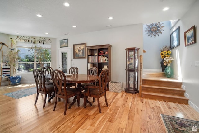 dining room with light wood-style flooring, recessed lighting, and baseboards