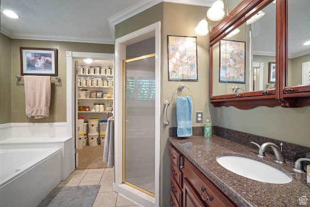 bathroom featuring a stall shower, ornamental molding, vanity, tile patterned floors, and a garden tub