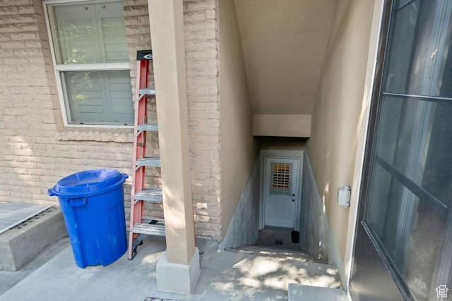 doorway to property with brick siding