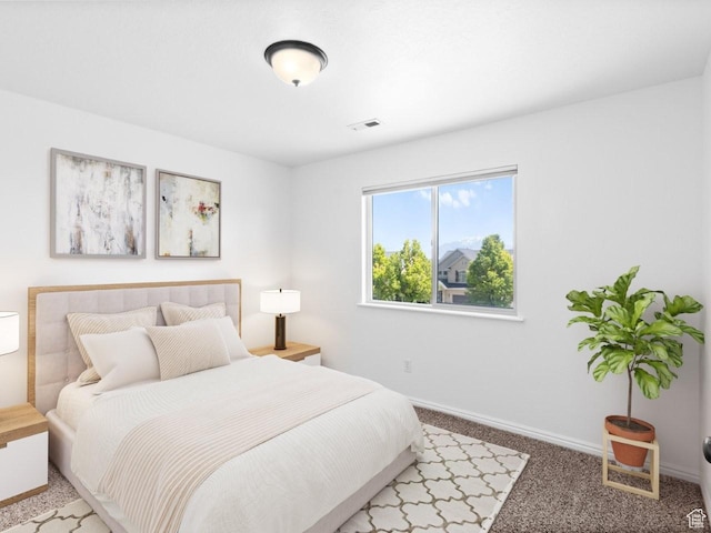 bedroom with light carpet and baseboards