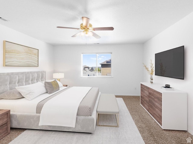 carpeted bedroom featuring a ceiling fan and baseboards