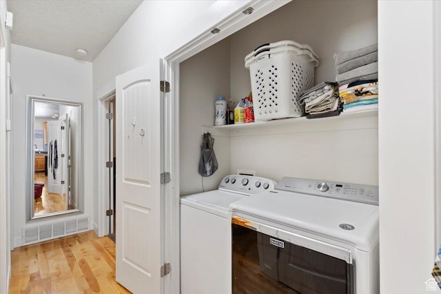 2099 W 700 S, Syracuse, UT 84075 - laundry room featuring washer and clothes dryer, light wood-style flooring, and a textured ceiling