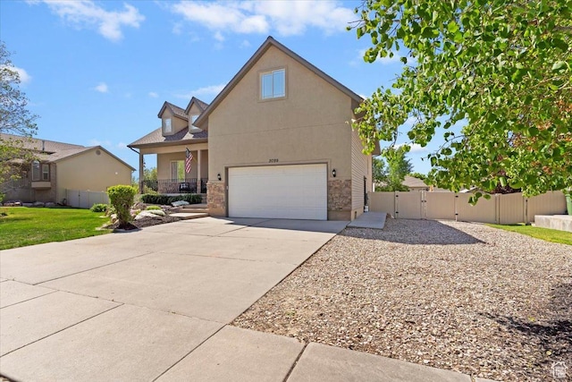 2099 W 700 S, Syracuse, UT 84075 - traditional-style house with a gate, driveway, an attached garage, fence, and stone siding