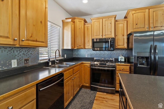 2099 W 700 S, Syracuse, UT 84075 - kitchen featuring black appliances, a sink, dark countertops, light wood finished floors, and backsplash