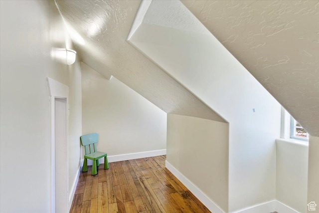 2099 W 700 S, Syracuse, UT 84075 - bonus room featuring wood-type flooring, lofted ceiling, baseboards, and a textured ceiling