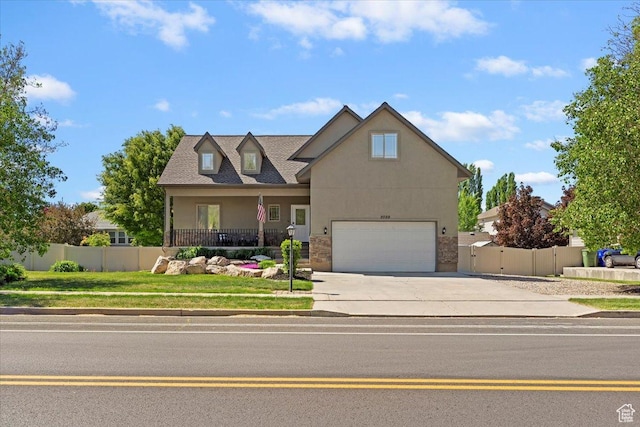 2099 W 700 S, Syracuse, UT 84075 - view of front of home with concrete driveway, fence, stucco siding, and a garage