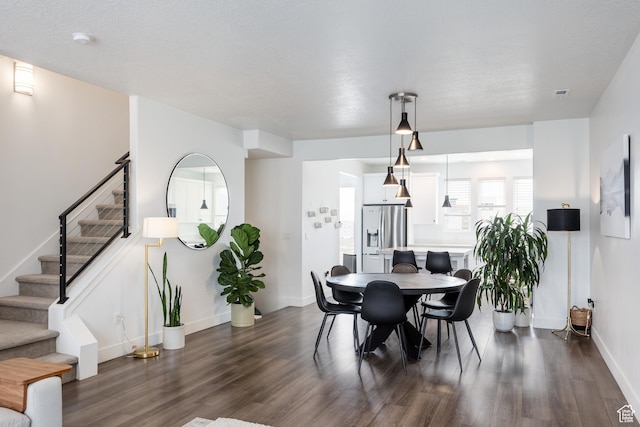 dining room with dark wood finished floors, stairway, and baseboards