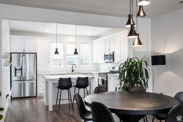 dining space with dark wood finished floors and recessed lighting