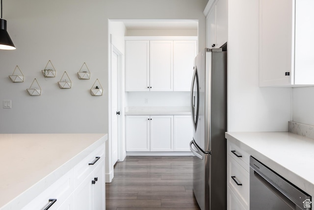kitchen with stainless steel appliances, light countertops, and white cabinetry