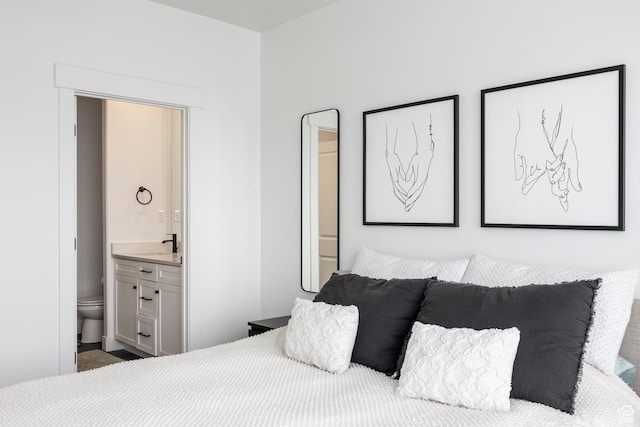 bedroom with ensuite bath and a sink