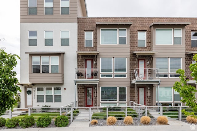 multi unit property featuring brick siding and stucco siding
