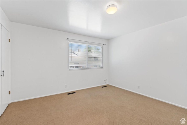 empty room with carpet and baseboards