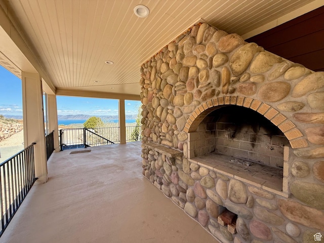 3431 S Panorama Dr, Garden City, UT 84028 - view of patio with a water view and an outdoor stone fireplace