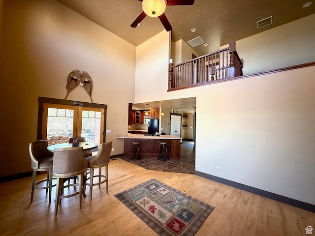 3431 S Panorama Dr, Garden City, UT 84028 - dining space with french doors, a ceiling fan, baseboards, hardwood / wood-style floors, and high vaulted ceiling