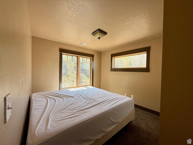 3431 S Panorama Dr, Garden City, UT 84028 - carpeted bedroom featuring a textured ceiling and baseboards