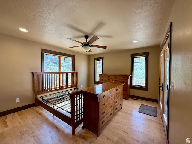 3431 S Panorama Dr, Garden City, UT 84028 - bedroom with a textured ceiling, baseboards, light wood-style floors, recessed lighting, and a ceiling fan