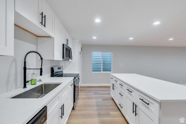2571 N Geranium Dr W Unit 239, Saratoga Springs, UT 84045 - kitchen with appliances with stainless steel finishes, a sink, recessed lighting, light wood finished floors, and light countertops