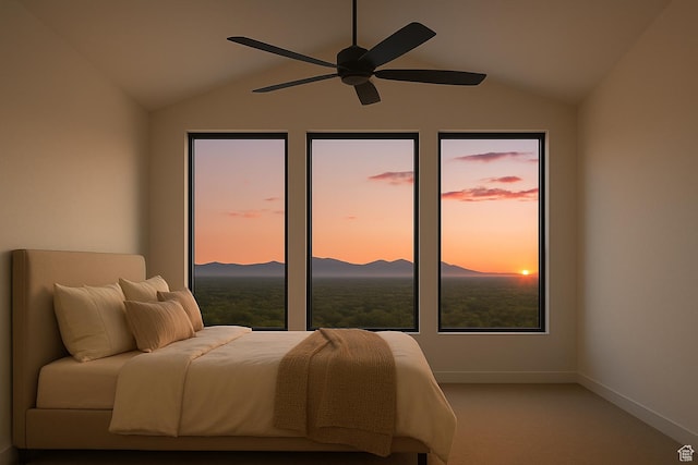 bedroom with lofted ceiling, carpet flooring, baseboards, a mountain view, and a ceiling fan