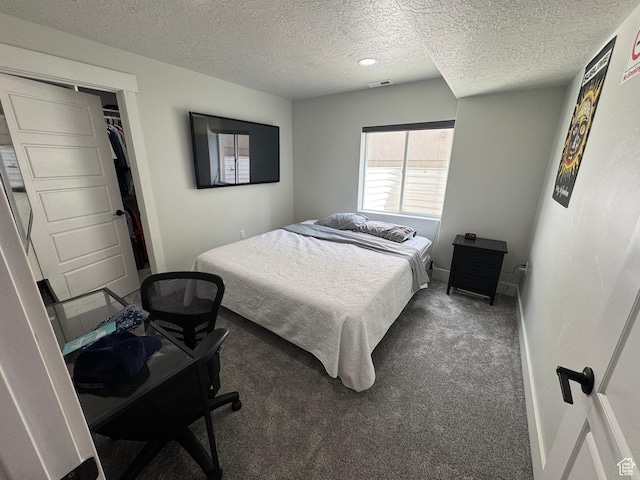 bedroom with a textured ceiling, carpet, and baseboards