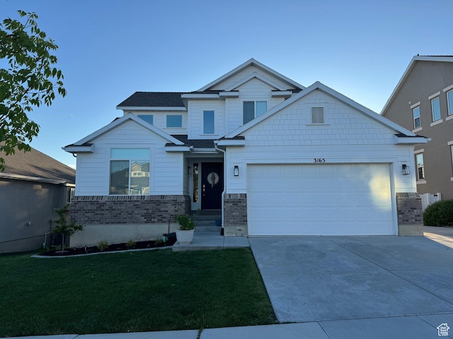 craftsman-style house with an attached garage, driveway, and a front lawn