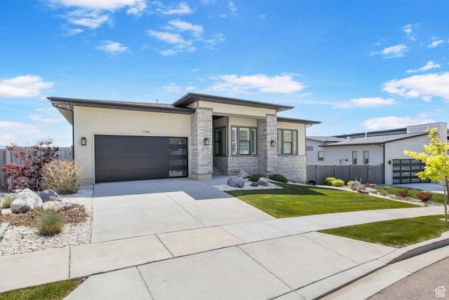 modern home featuring a garage, driveway, and stucco siding