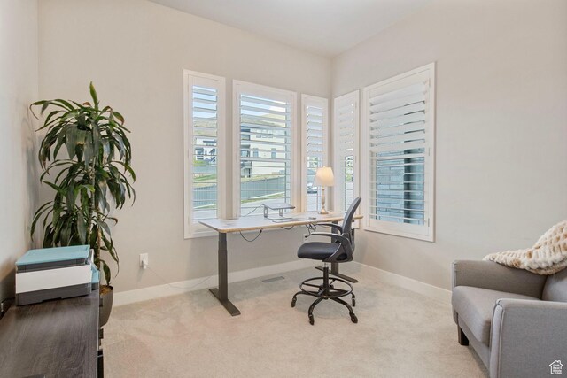 carpeted office space featuring baseboards