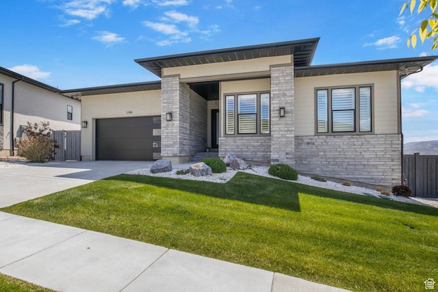 view of front facade with stone siding, driveway, and a garage