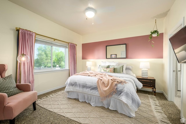 bedroom featuring light carpet, baseboards, and ceiling fan