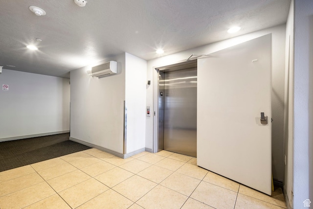 interior space with a wall mounted air conditioner, elevator, recessed lighting, a closet, and baseboards