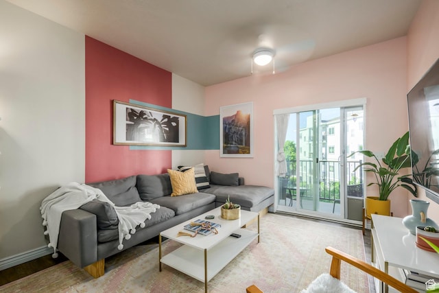 living area featuring wood finished floors and a ceiling fan