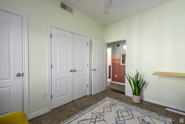 carpeted bedroom with baseboards, a closet, and a ceiling fan