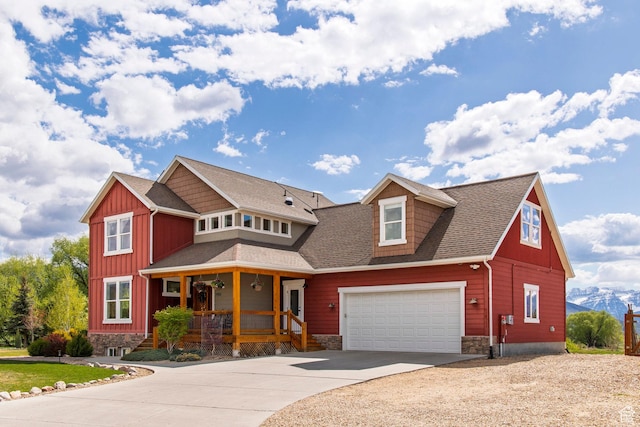 1920 S Wall St, Heber City, UT 84032 - view of front facade featuring covered porch, concrete driveway, board and batten siding, stone siding, and a shingled roof