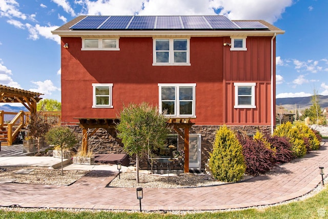 1920 S Wall St, Heber City, UT 84032 - rear view of house featuring board and batten siding, a patio area, and solar panels