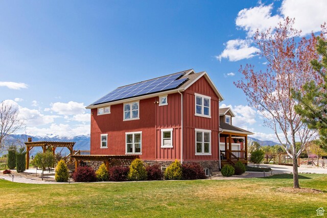 1920 S Wall St, Heber City, UT 84032 - view of side of property with solar panels, board and batten siding, a pergola, and a yard