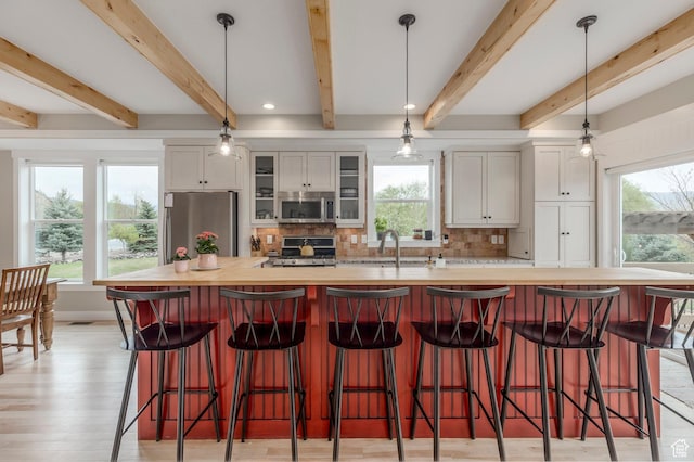 1920 S Wall St, Heber City, UT 84032 - kitchen with stainless steel appliances, a sink, tasteful backsplash, white cabinets, and beam ceiling