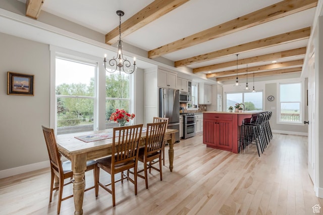 1920 S Wall St, Heber City, UT 84032 - dining area with a chandelier, baseboards, beam ceiling, and light wood finished floors