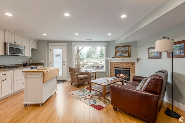 1920 S Wall St, Heber City, UT 84032 - living room with a glass covered fireplace, light wood-style flooring, recessed lighting, and baseboards